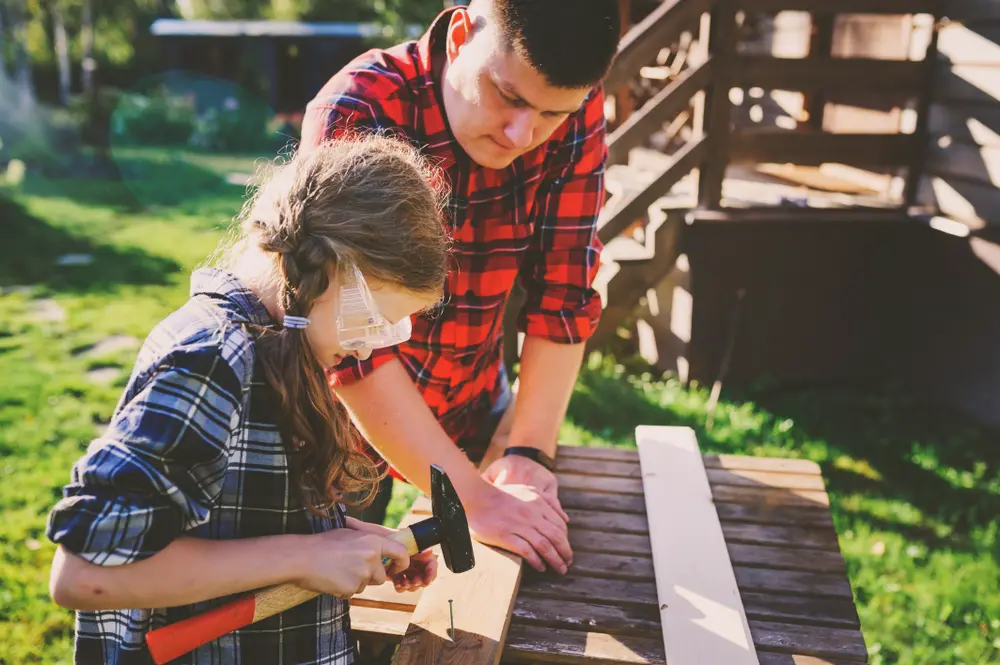 Image of father helping daughter, the 4 parenting styles at work
